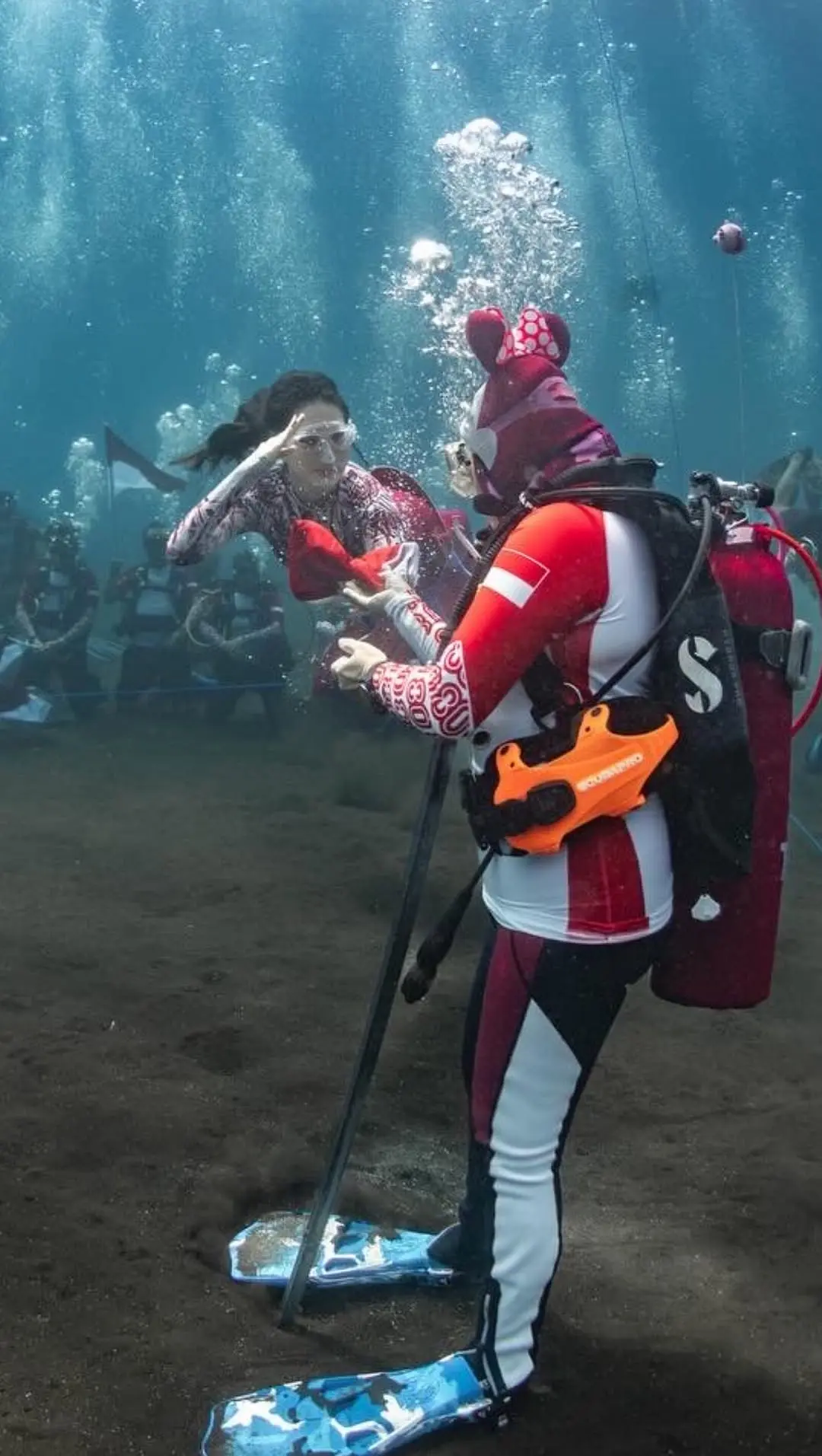 Underwater flag raising ceremony moment